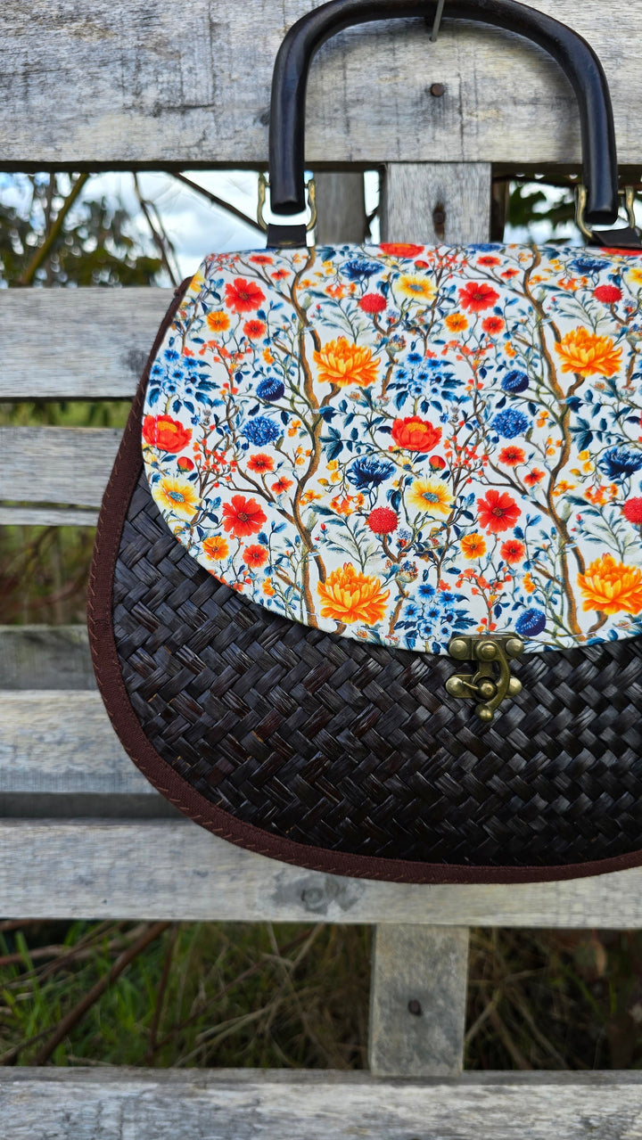 Handbag with floral pattern on a wooden surface