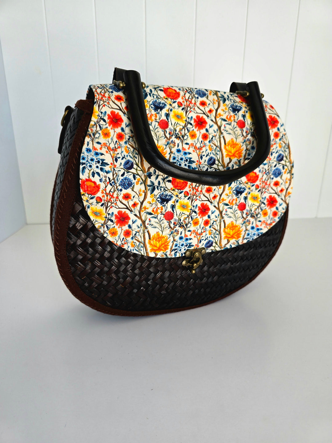 Handbag with floral pattern on a white background