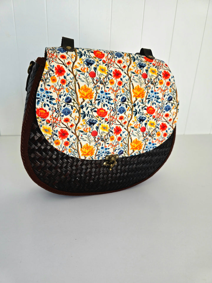 Handbag with floral pattern on a white background