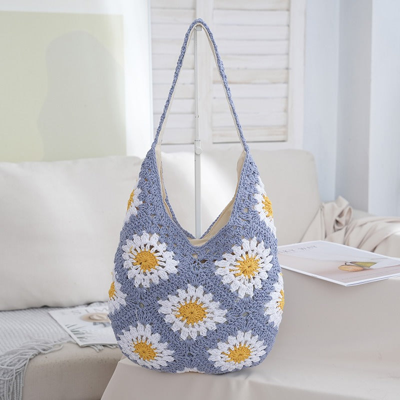 Crocheted bag with floral pattern on a couch
