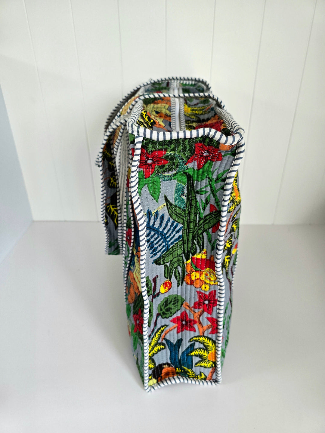 Tropical patterned bag with a zipper on a white background