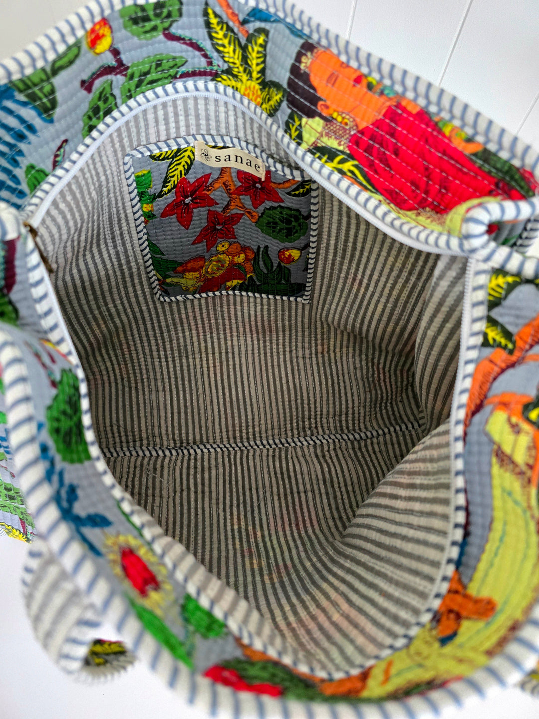 Close-up of a colorful fabric product with a brand label inside.