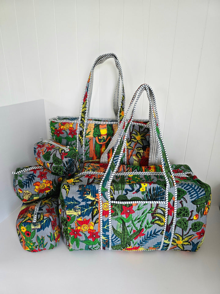 Set of colorful fabric bags with floral patterns on a white background