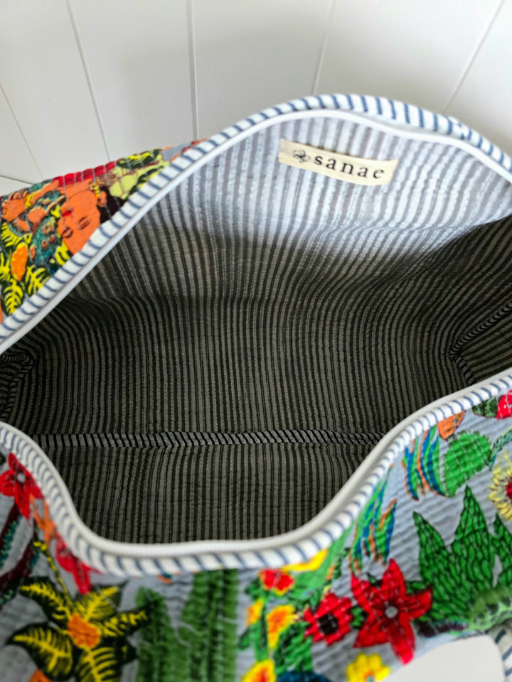 Colorful embroidered bag with floral patterns on a white background