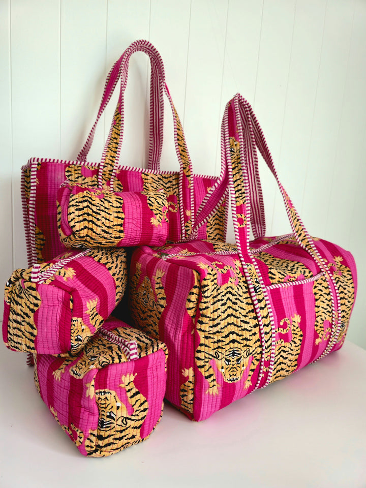 Set of pink and gold patterned bags on a white background