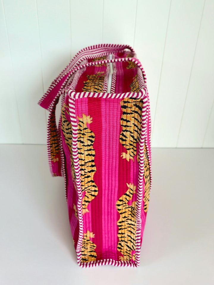 Colorful fabric bag with pink and yellow patterns on a white background
