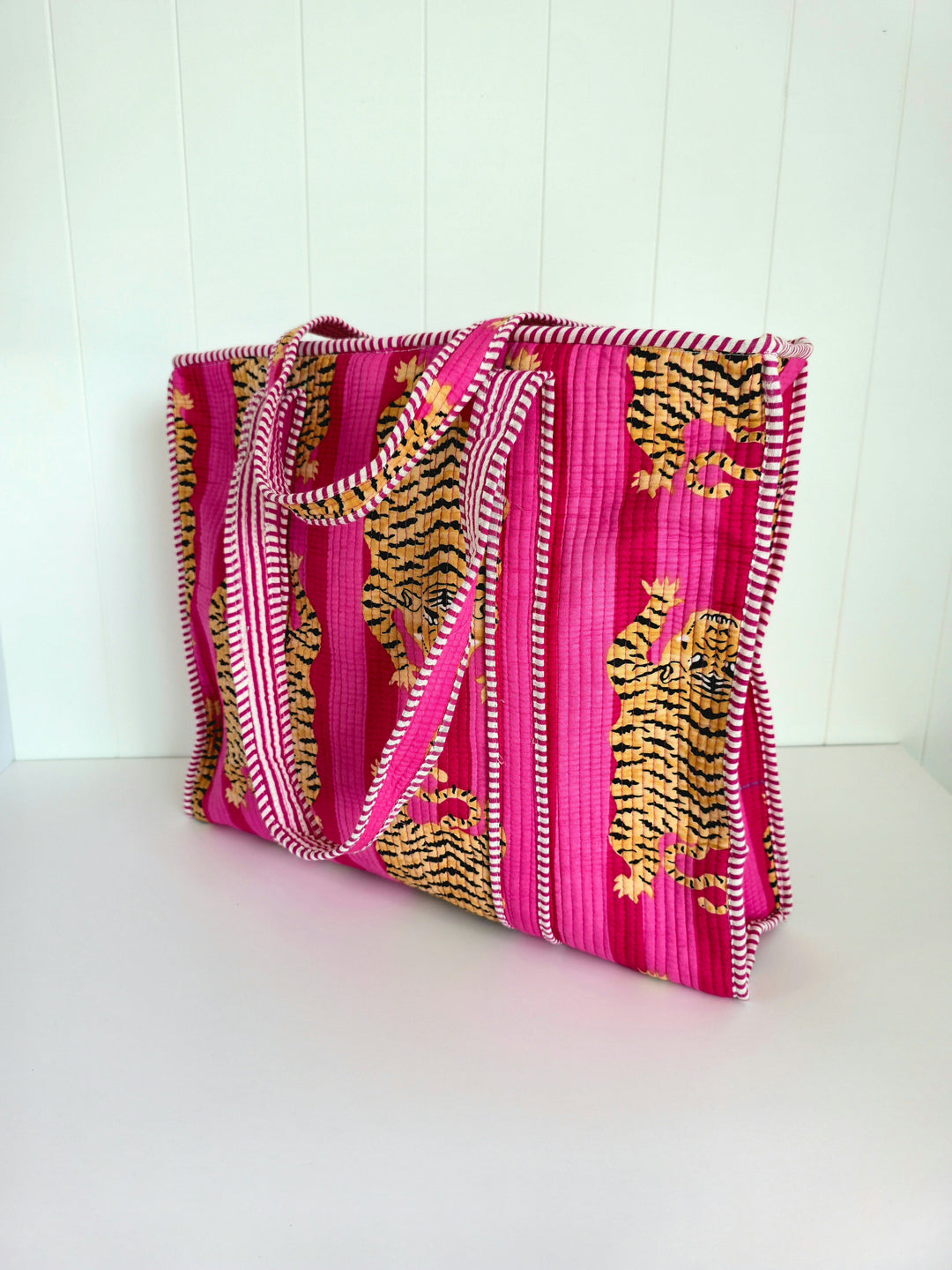 Pink tote bag with tiger design on a white background